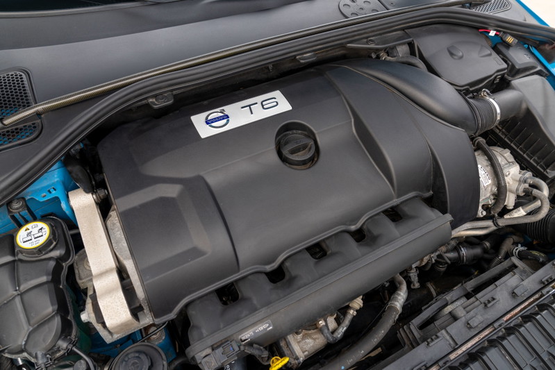 Close-up of a Volvo T6 engine, featuring the iconic T6 badge on the black engine cover in a 2015 V60 Polestar.