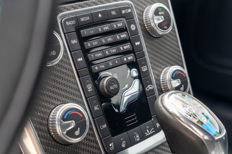 Close-up of the carbon fiber interior trim and climate controls on a 2015 Volvo V60 Polestar.