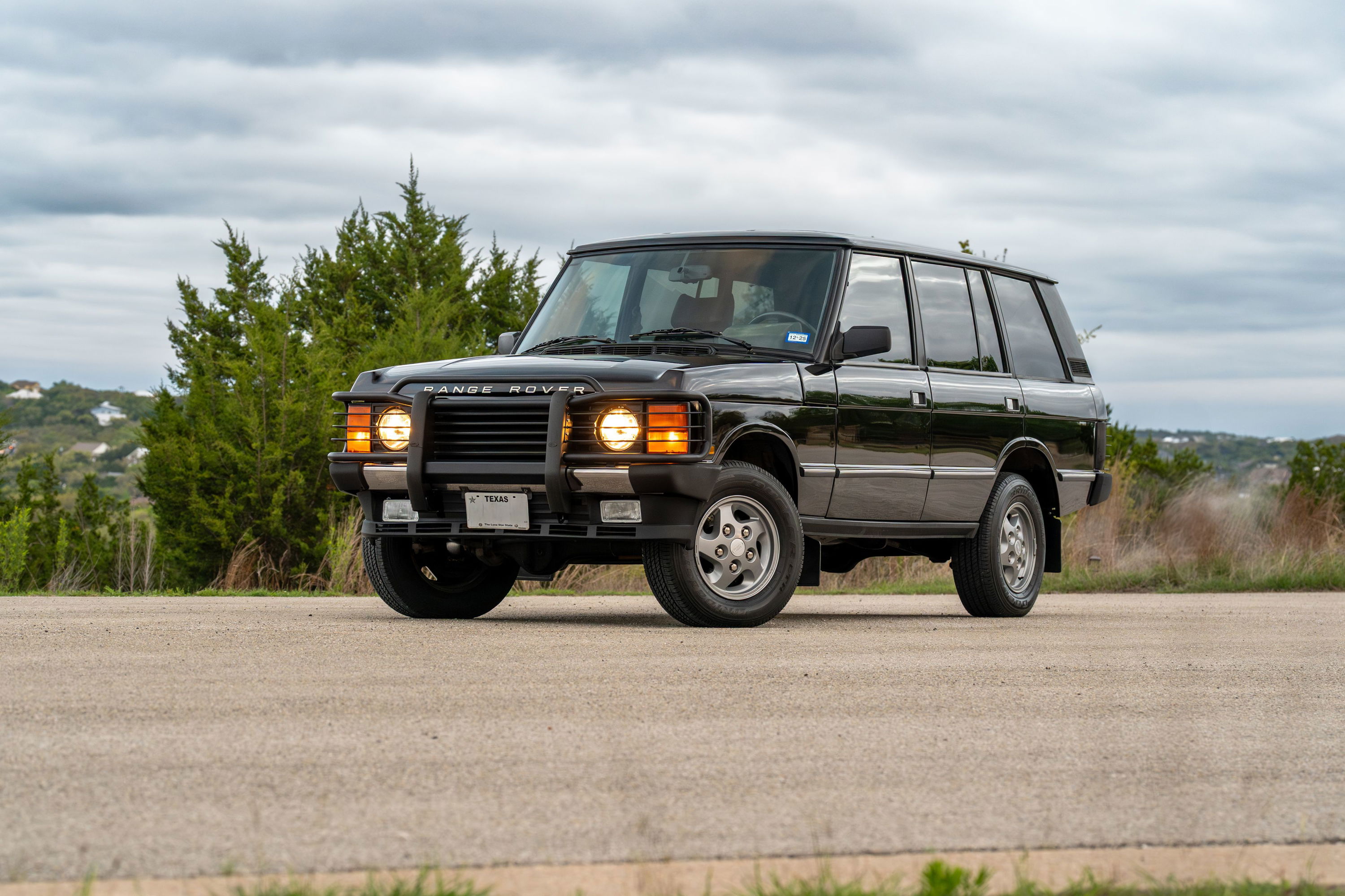 Black 1994 Land Rover Range Rover County LWB with silver rims and chrome trim.