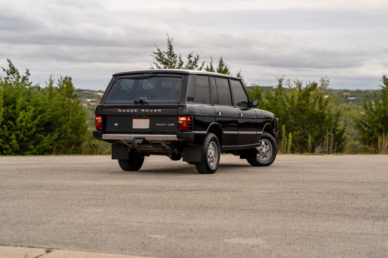 1994 black Land Rover Range Rover County LWB rear quarter view with chrome rims.