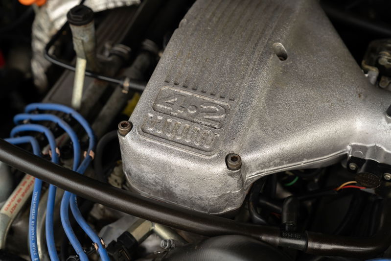 Close-up of a 1994 Range Rover County LWB engine with a "4.2" badge on the intake manifold.
