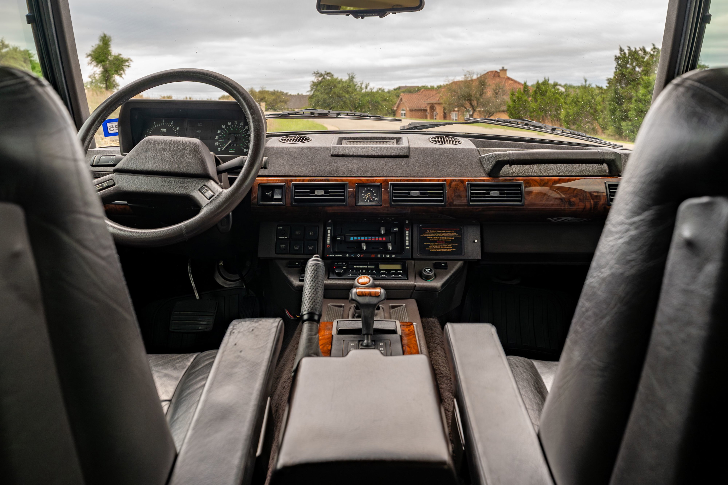 1994 Range Rover County LWB interior, featuring wood trim, leather seats, and automatic gear shifter.