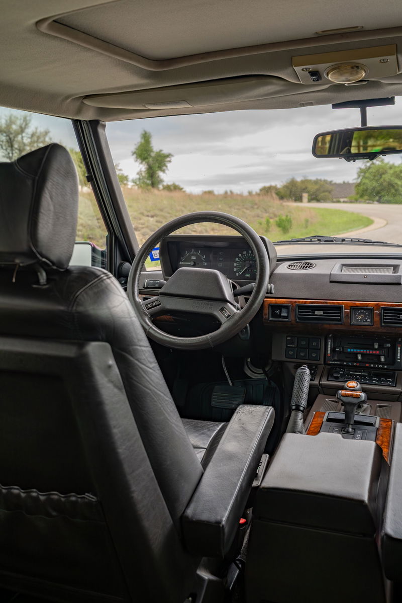 Interior of a 1994 Land Rover Range Rover County LWB with wood trim and leather seats.