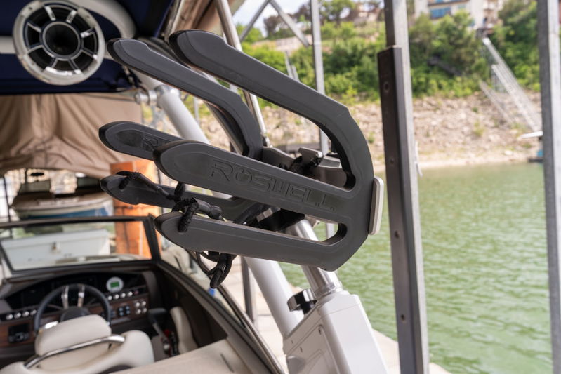 A gray surfboard rack on a Cobalt R7 Surf boat, mounted to the tower.