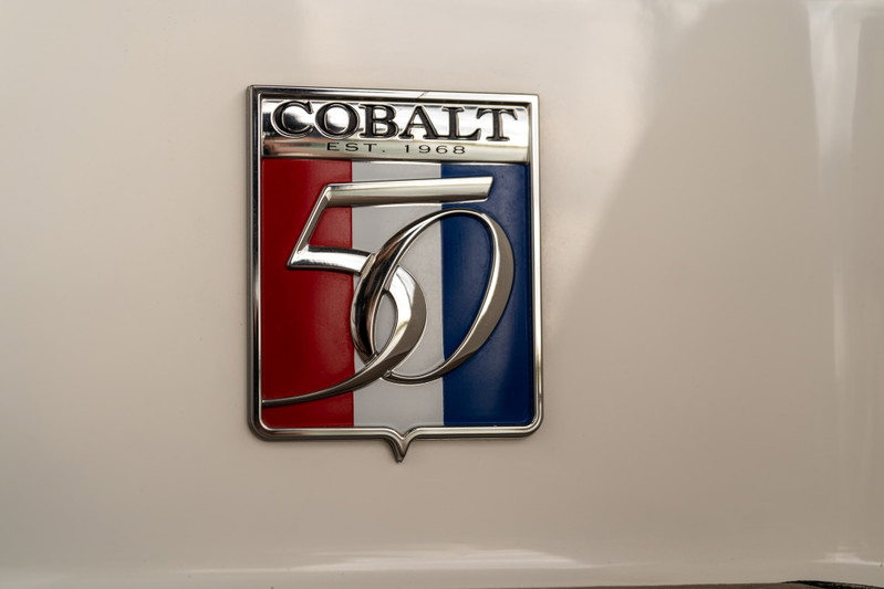 Close-up of a white 2018 Cobalt R7 Surf Boat emblem with "50 EST. 1968" text.