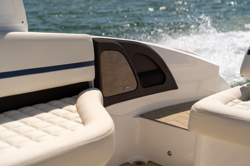 Interior of a 2025 Cobalt R7 Surf boat with white quilted upholstery and dark trim.