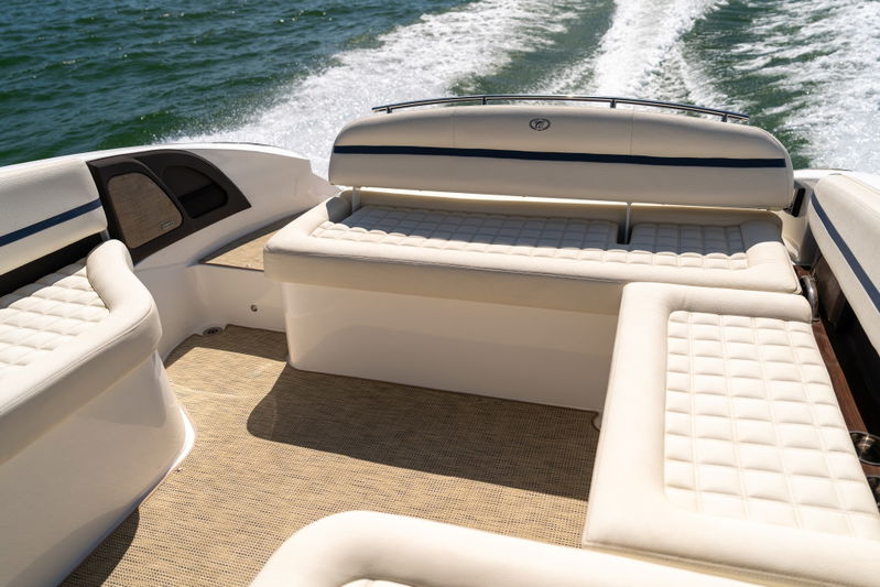 White Cobalt R7 Surf boat interior with upholstered seating and blue trim.