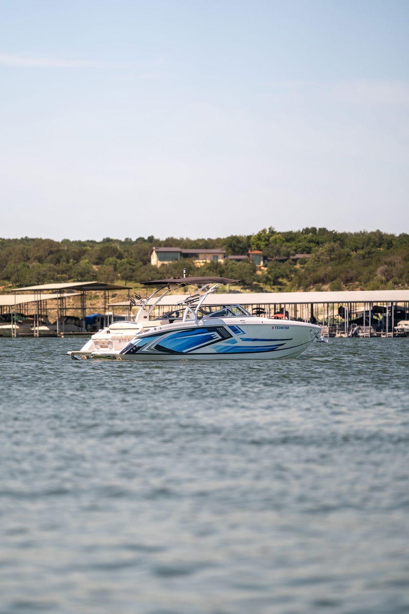 2025 Cobalt R7 Surf boat with blue and white livery on the water.