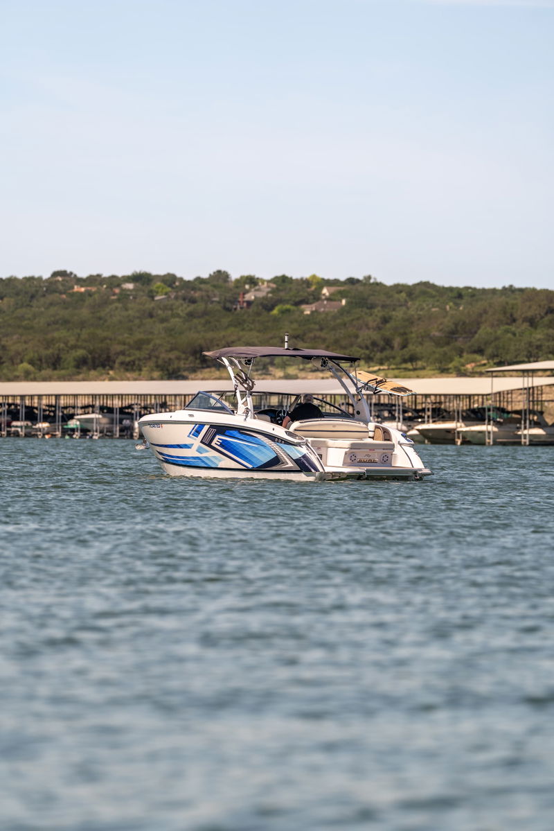2025 Cobalt R7 Surf boat with a blue and white hull livery, on the water.