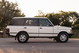 Side profile of a white 1995 Land Rover Range Rover County with silver five-spoke rims.