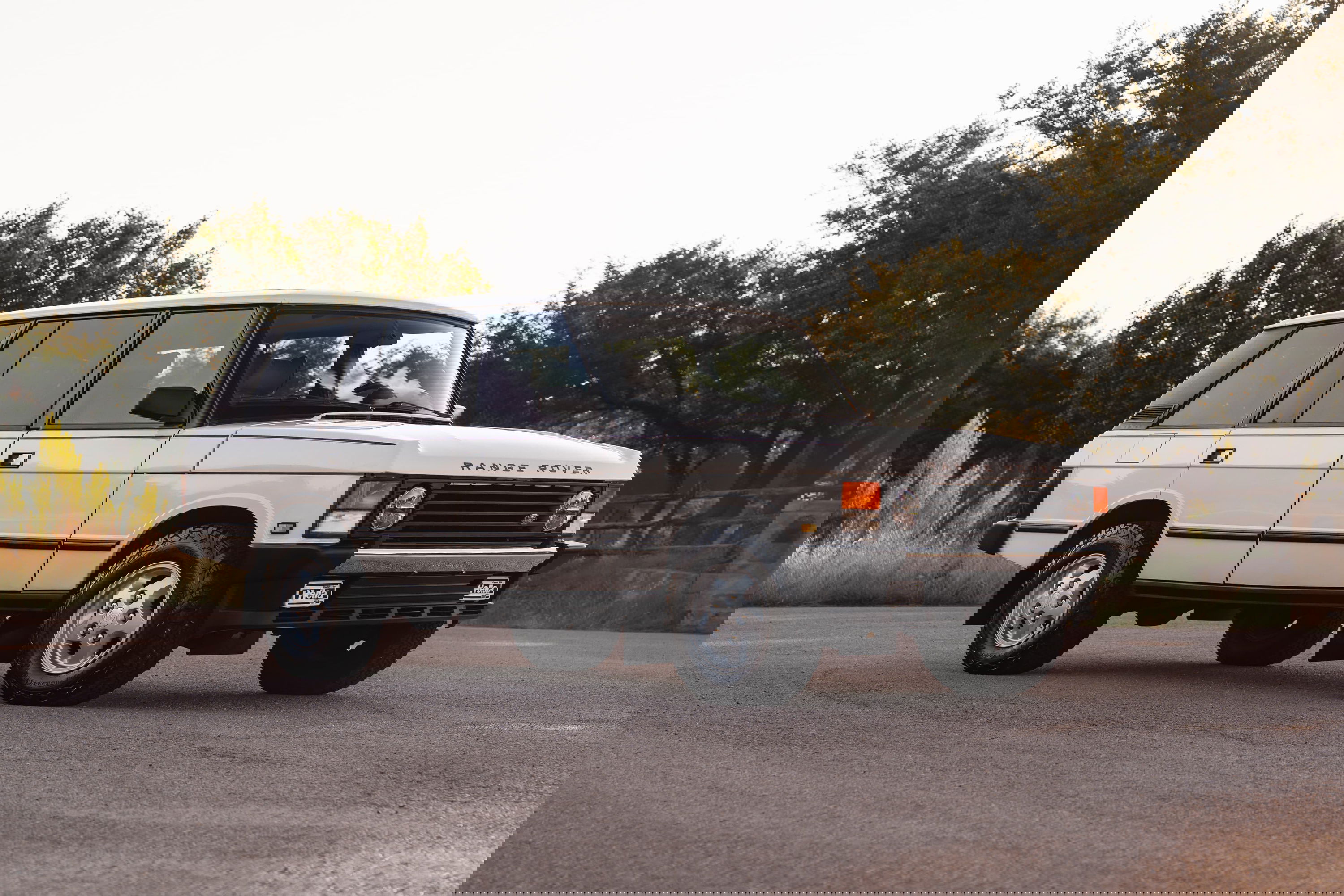 White 1995 Land Rover Range Rover County Classic with chrome trim and alloy rims.