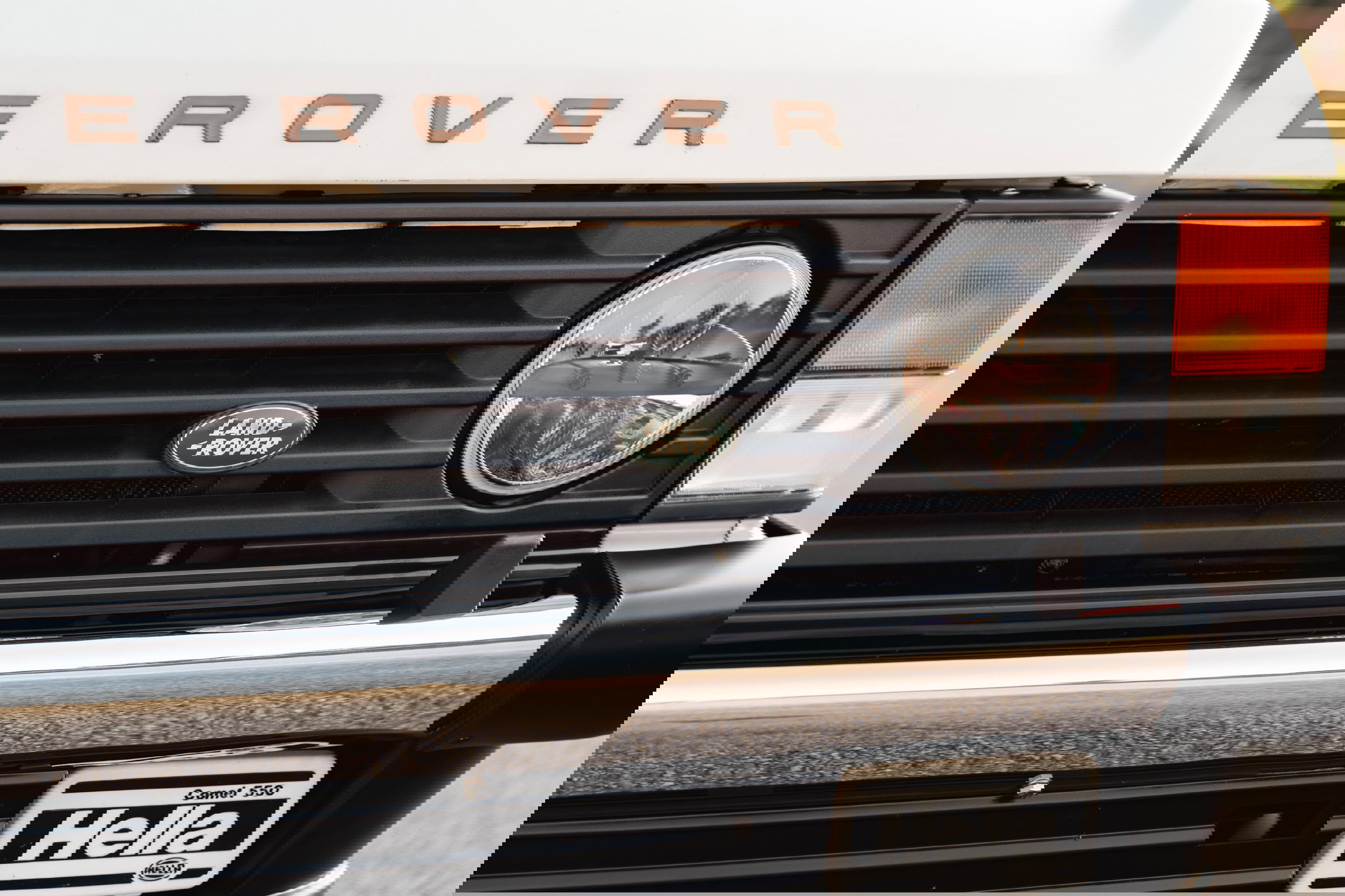 Close-up of a white 1995 Land Rover Range Rover County grille, featuring round headlights and a chrome bumper.