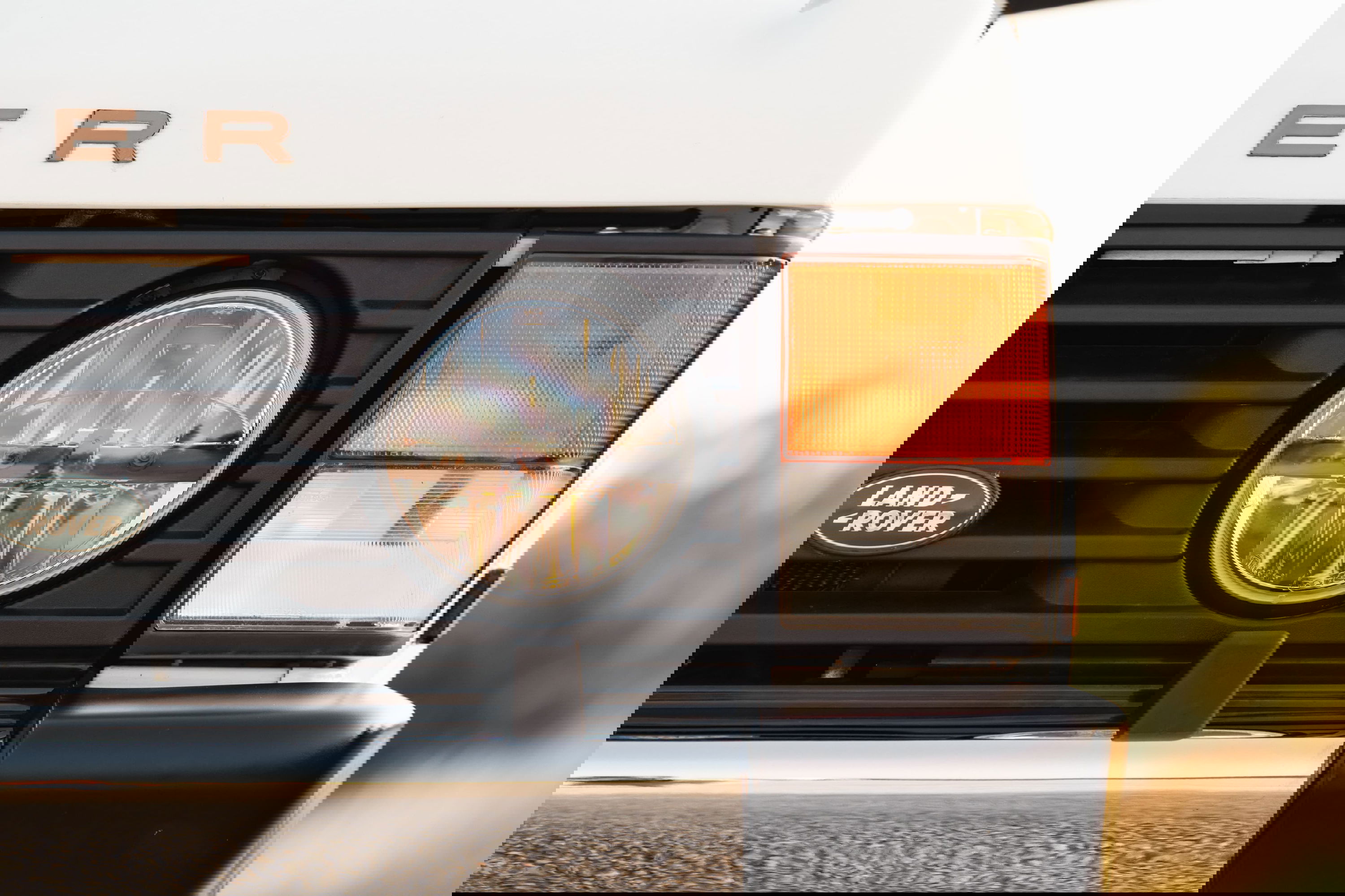 Front view of a white 1995 Land Rover Range Rover County with round LED headlight and amber turn signal.