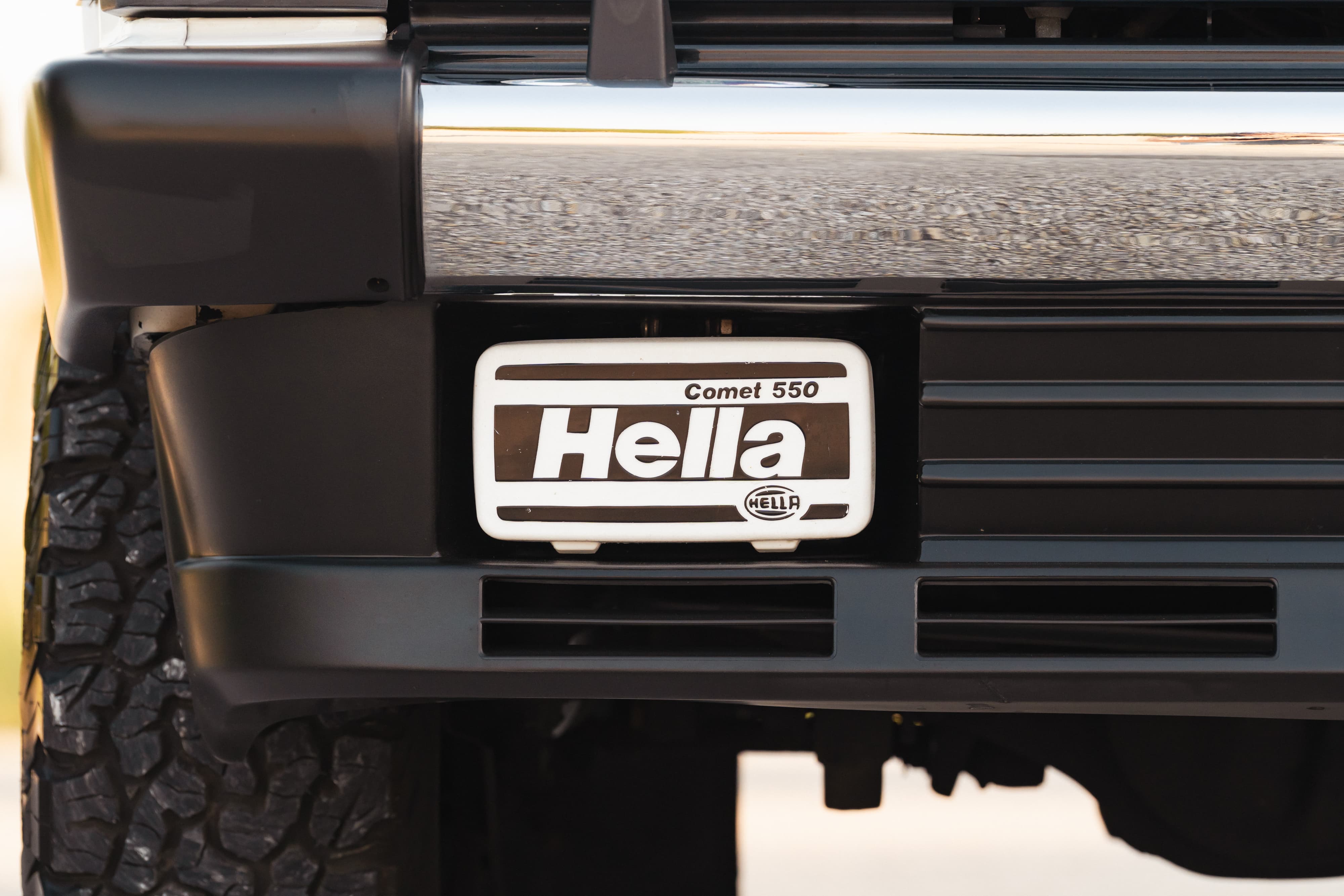 1995 Range Rover County with Hella Comet 550 fog lights and aggressive off-road tires.