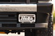 Front bumper of a white 1995 Land Rover Range Rover County with Hella Comet 550 fog lights.
