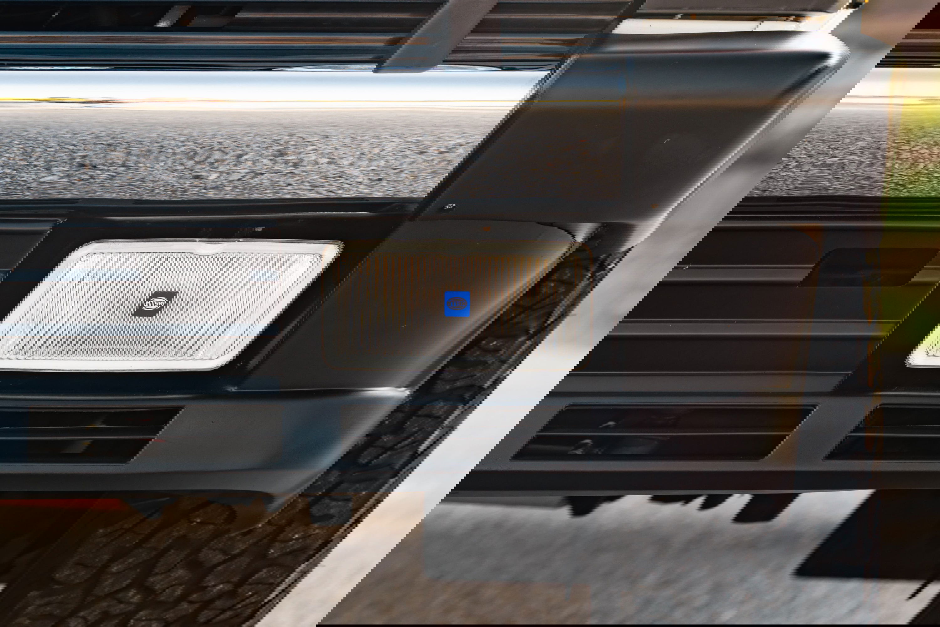 Front view of a white 1995 Land Rover Range Rover County, showing its black bumper and Hella fog light.