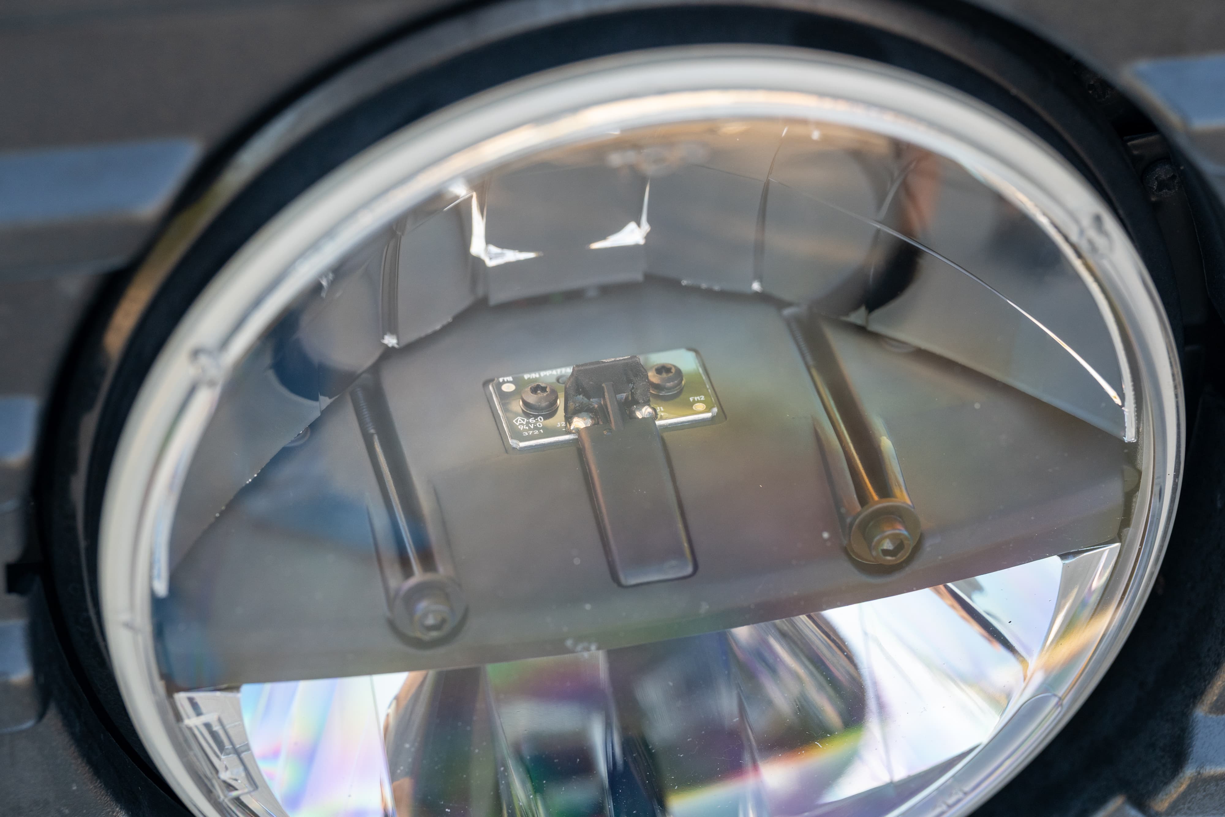 Close-up of a 1995 Land Rover Range Rover County headlight assembly.