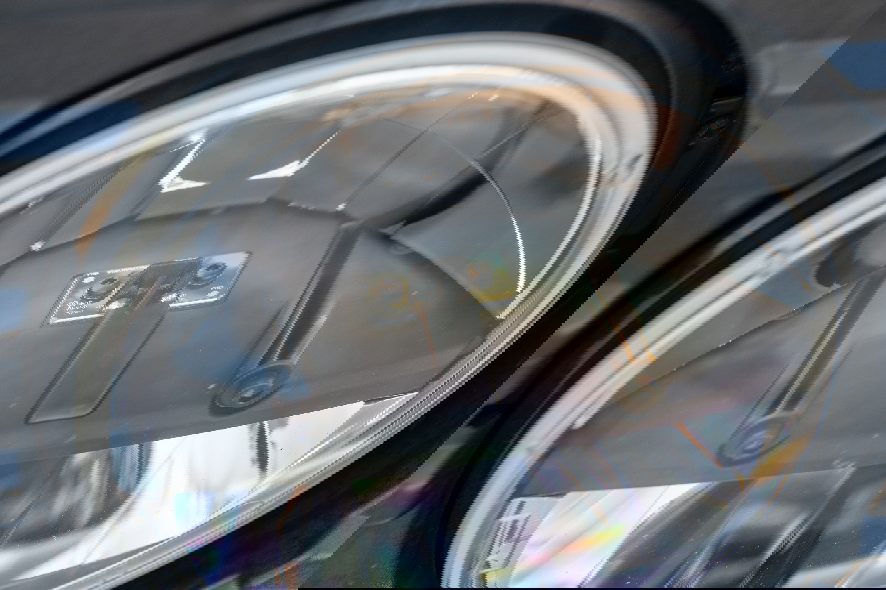 Close-up of a 1995 Land Rover Range Rover County headlight assembly.