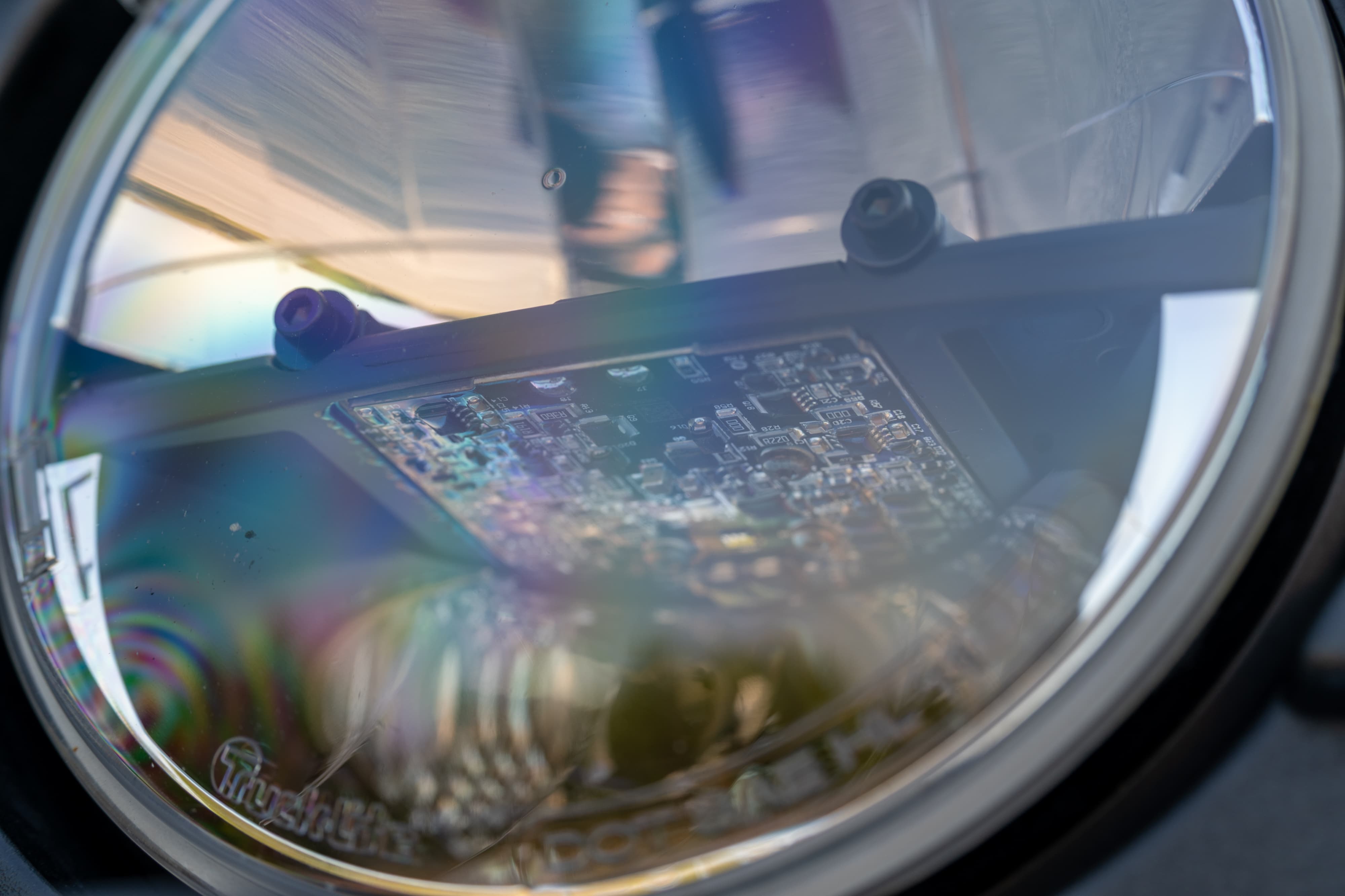 Closeup of a 1995 white Land Rover Range Rover County headlight assembly, showing LED circuit board.