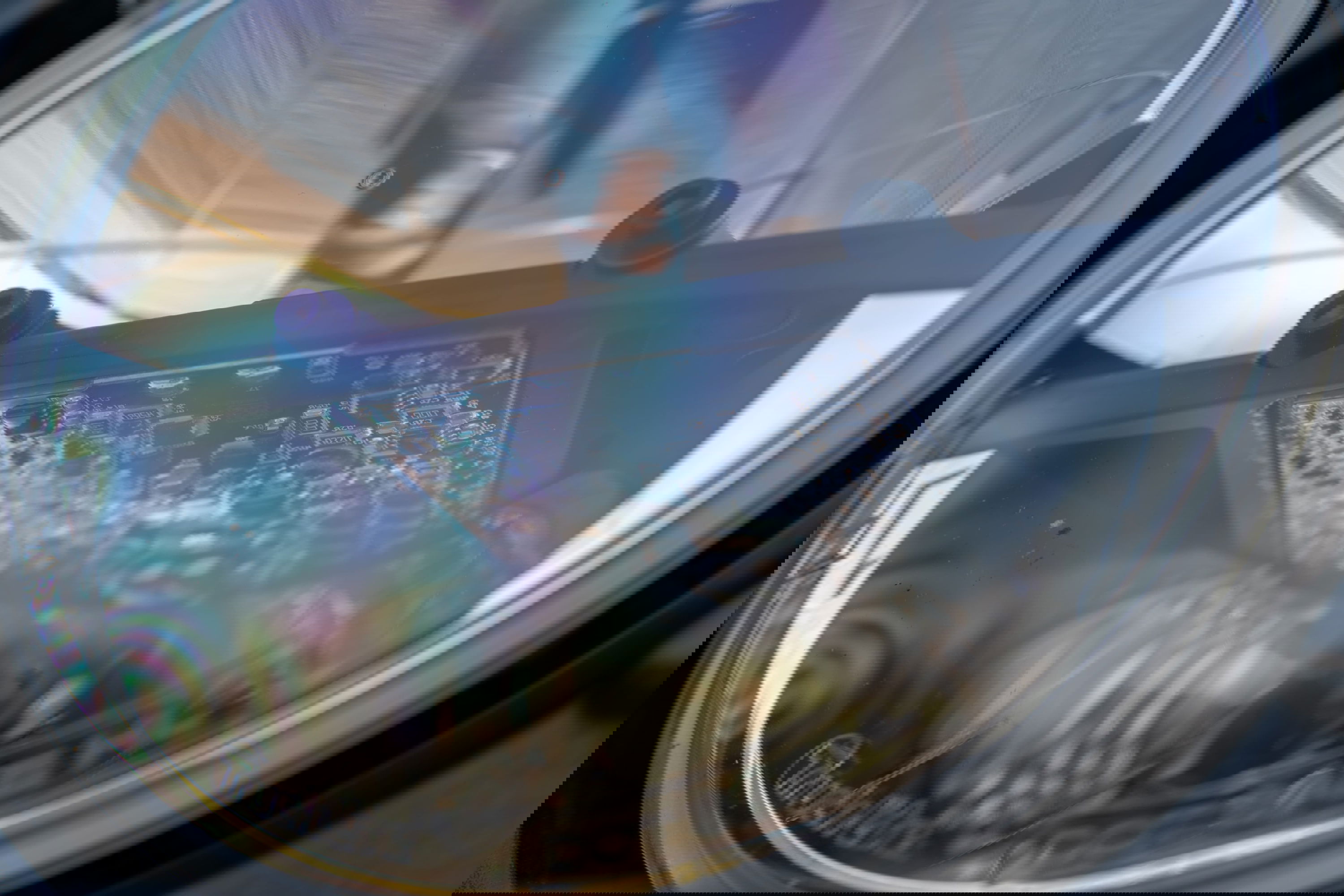 Closeup of a 1995 white Land Rover Range Rover County headlight assembly, showing LED circuit board.