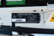 Close-up of the VIN plate and emissions sticker on a white 1995 Land Rover Range Rover County.