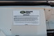 Close-up of a sticker on a white 1995 Land Rover Range Rover County with "Genuine Parts" text.