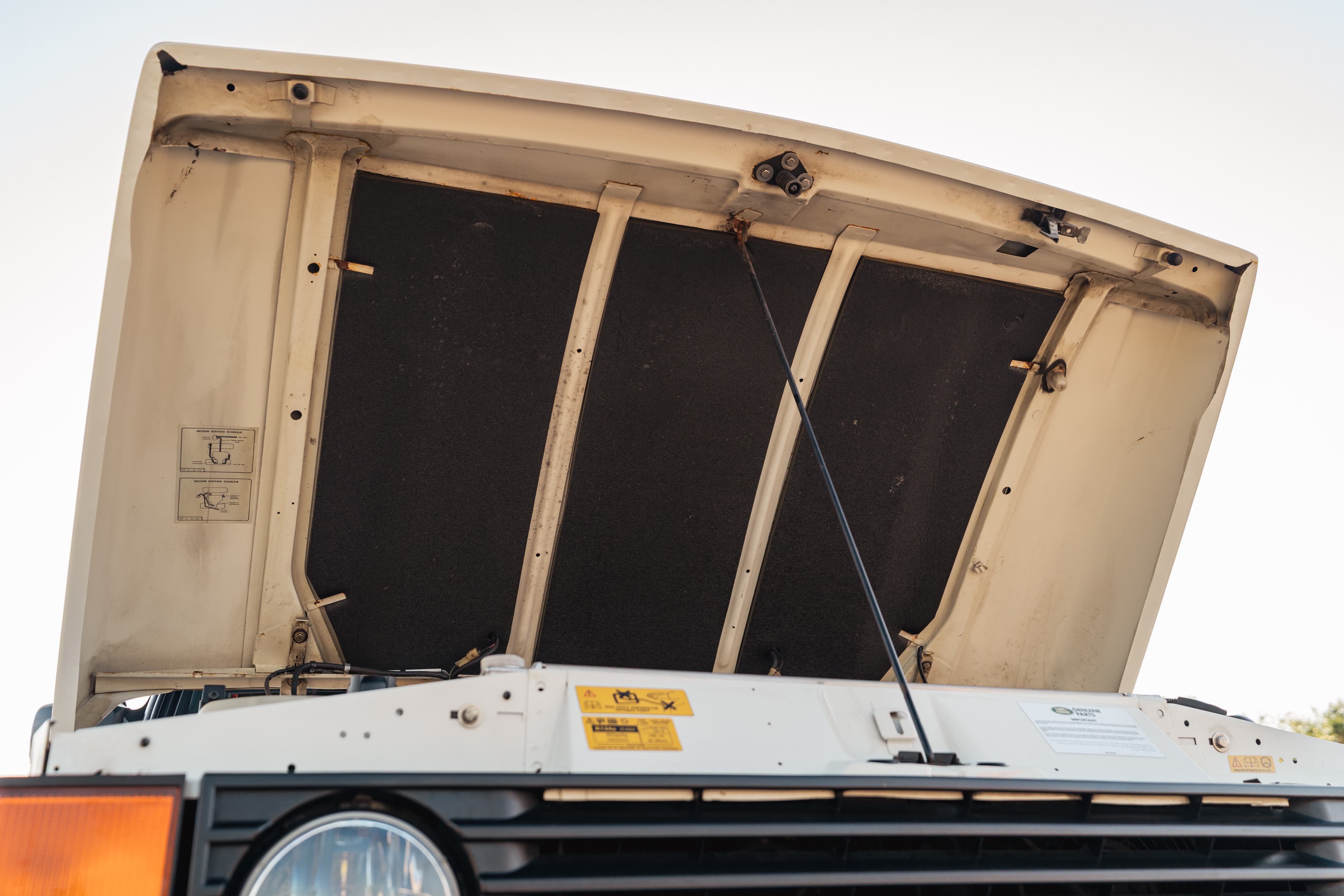 1995 Range Rover County hood insulation. Front grille and orange turn signal visible.