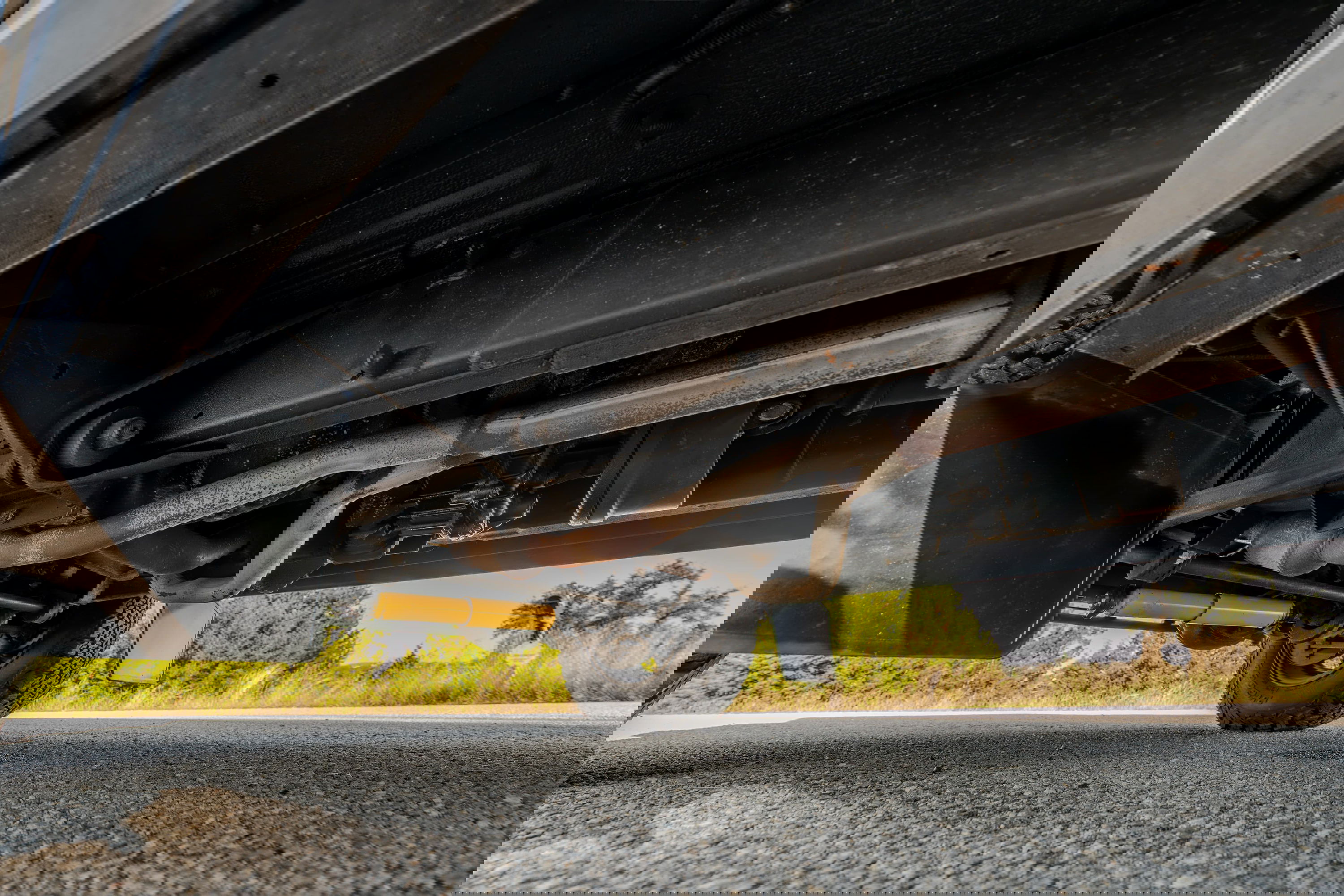 Underside view of a white 1995 Land Rover Range Rover County showing the exhaust system and suspension.