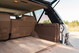 1995 Land Rover Range Rover County: tan carpeted cargo area with brown trim and open tailgate.