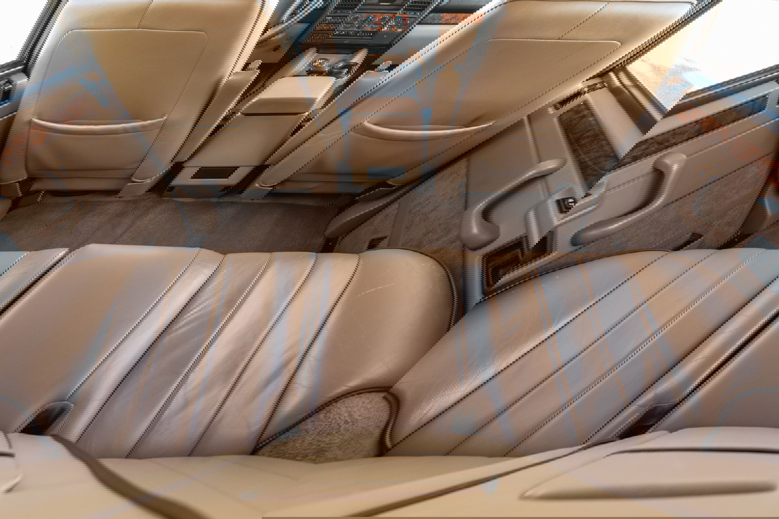 Interior view of a 1995 Land Rover Range Rover County's tan leather seats and wood trim.