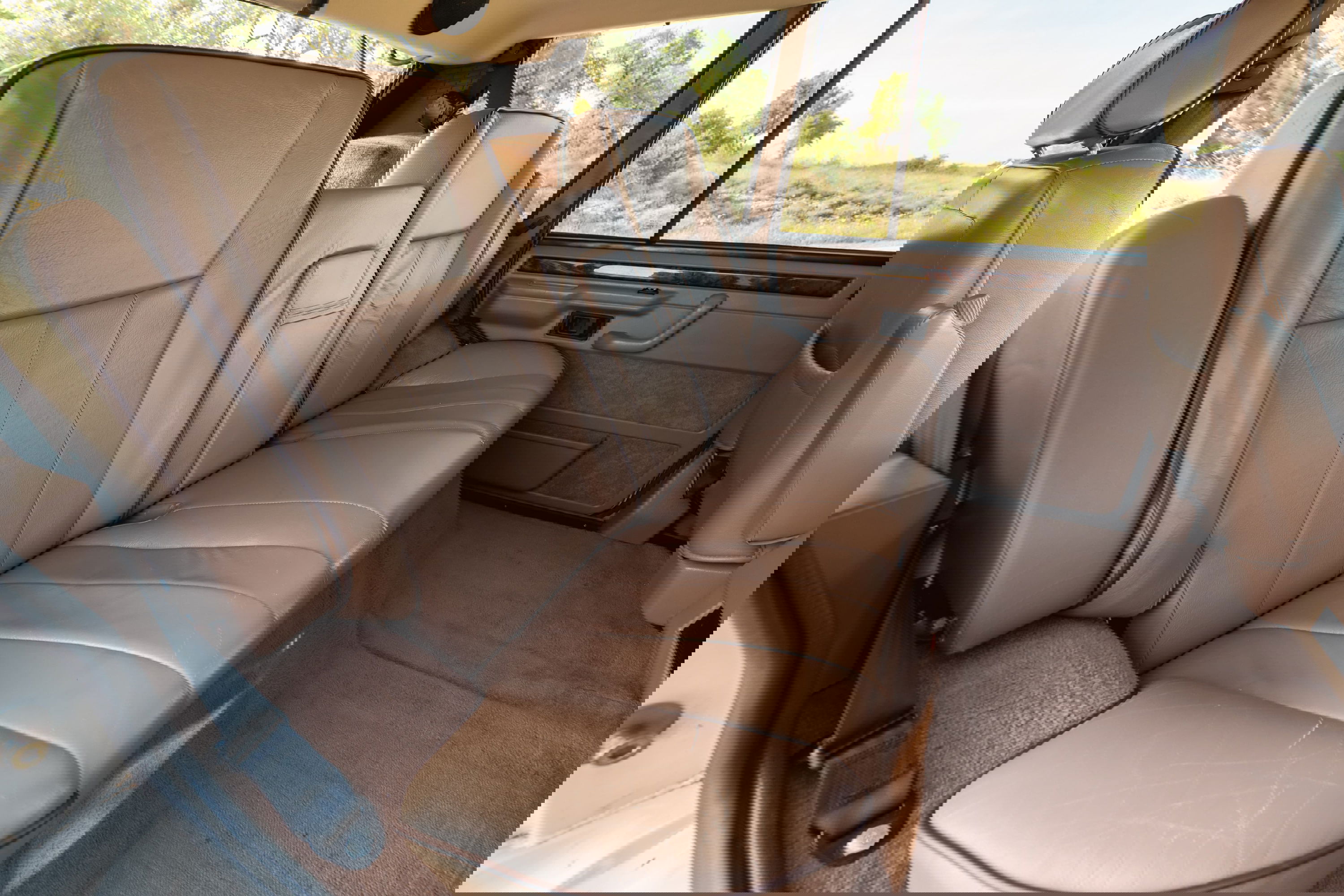 1995 Range Rover County interior: tan leather rear seats, wood trim, tan carpet.