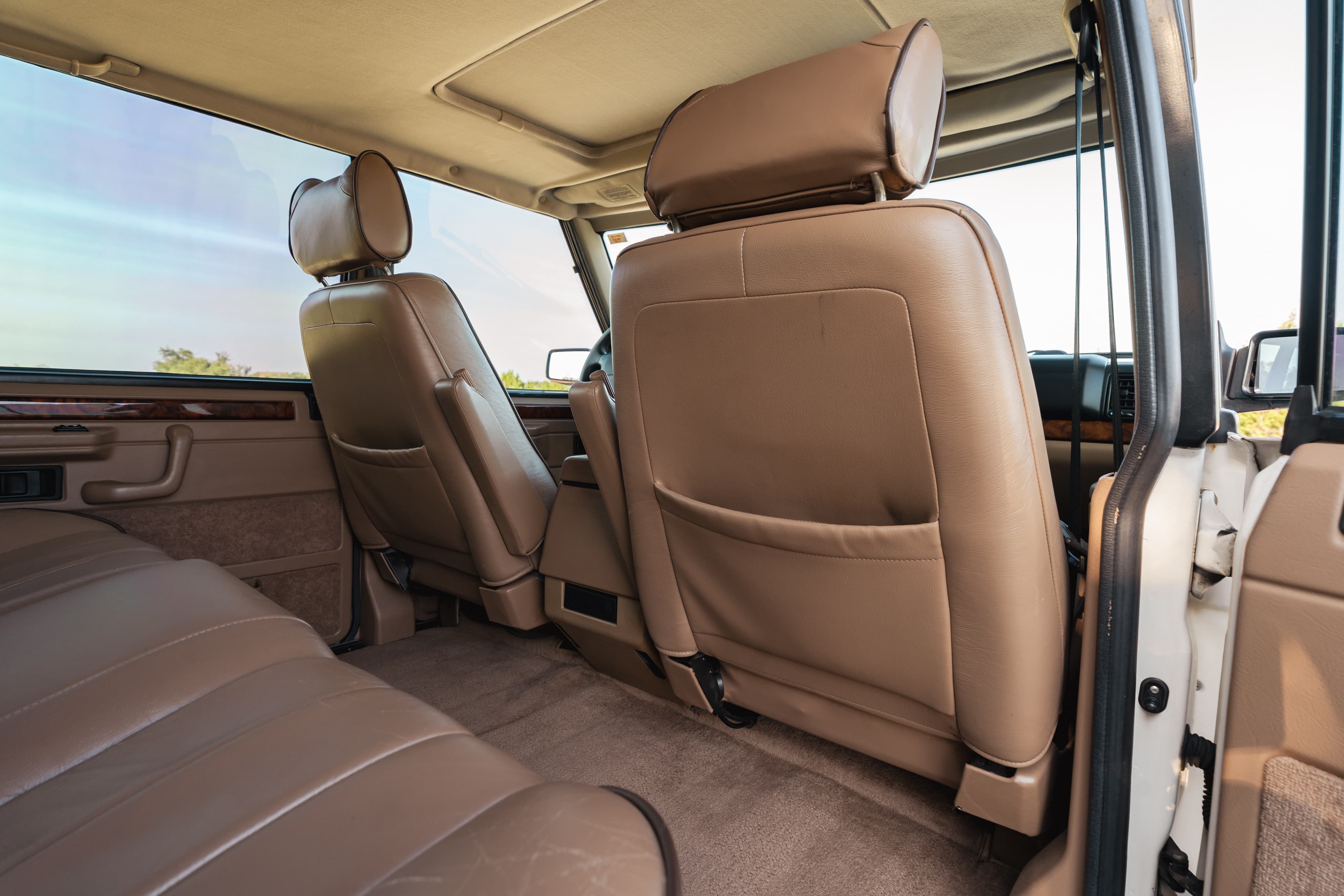 1995 Range Rover County interior: tan leather seats, wood trim, sunroof.