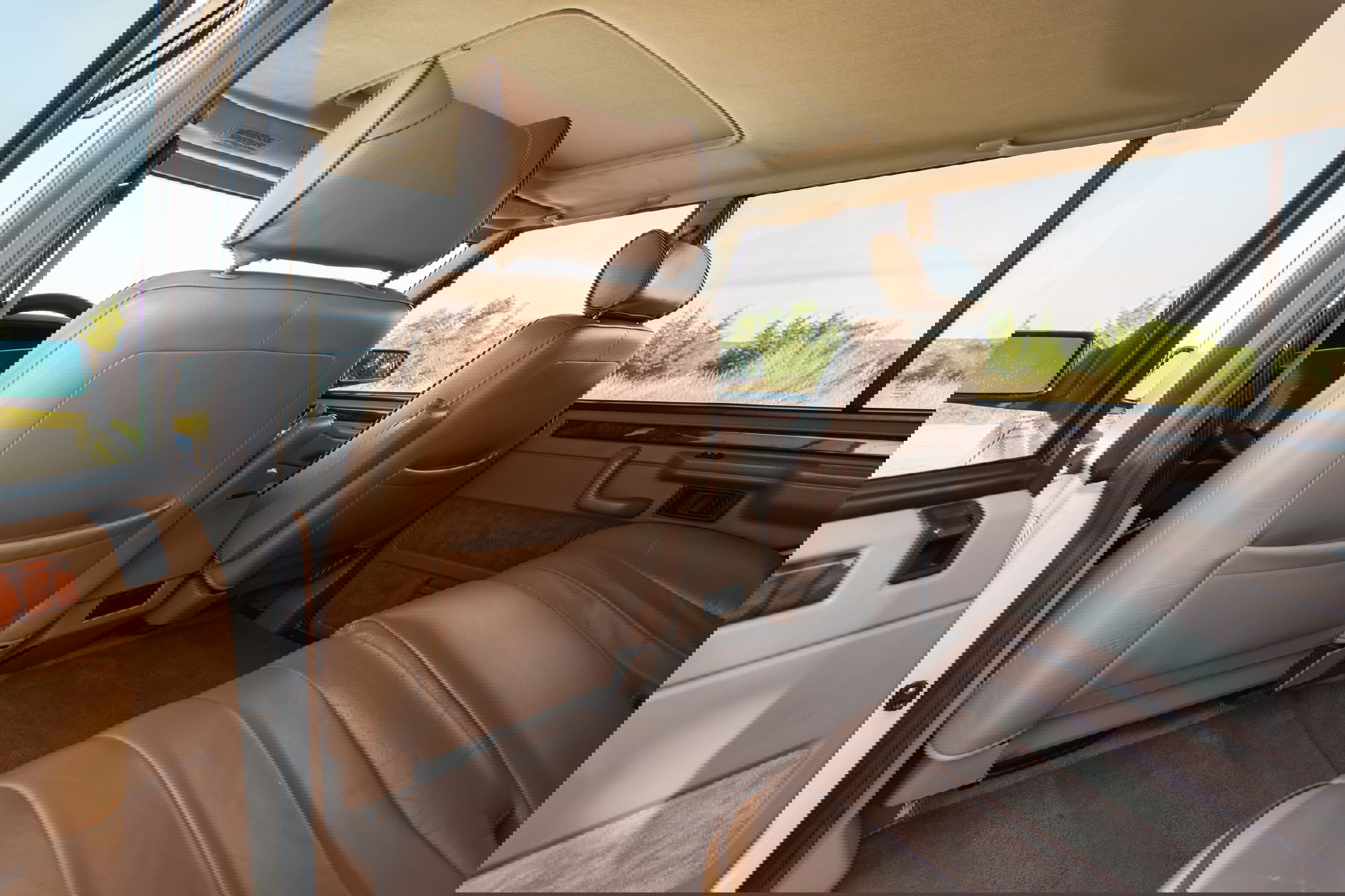 Interior of a white 1995 Land Rover Range Rover County, tan leather seats and trim.