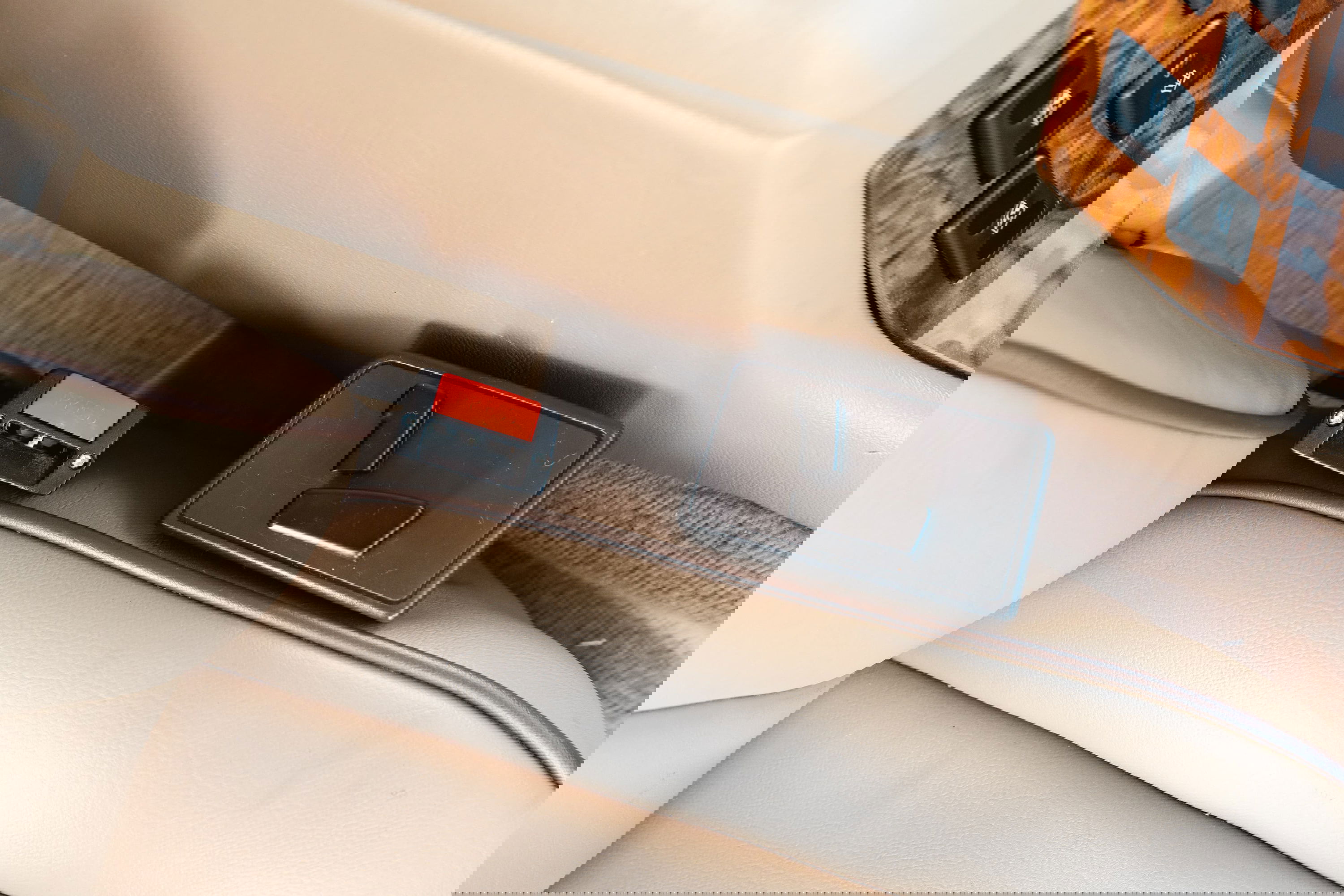 1995 white Land Rover Range Rover County seatbelt buckle and seat control panel.