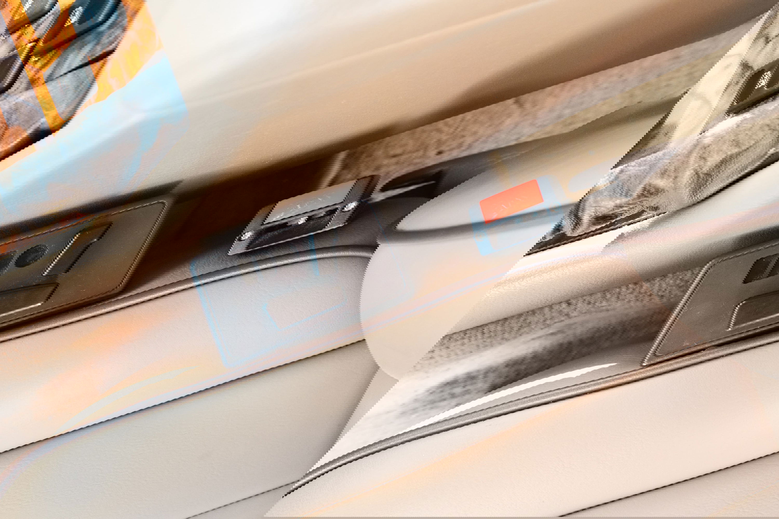 1995 Land Rover Range Rover County interior: tan leather seats, wood trim, seat belt buckle, and seat controls.