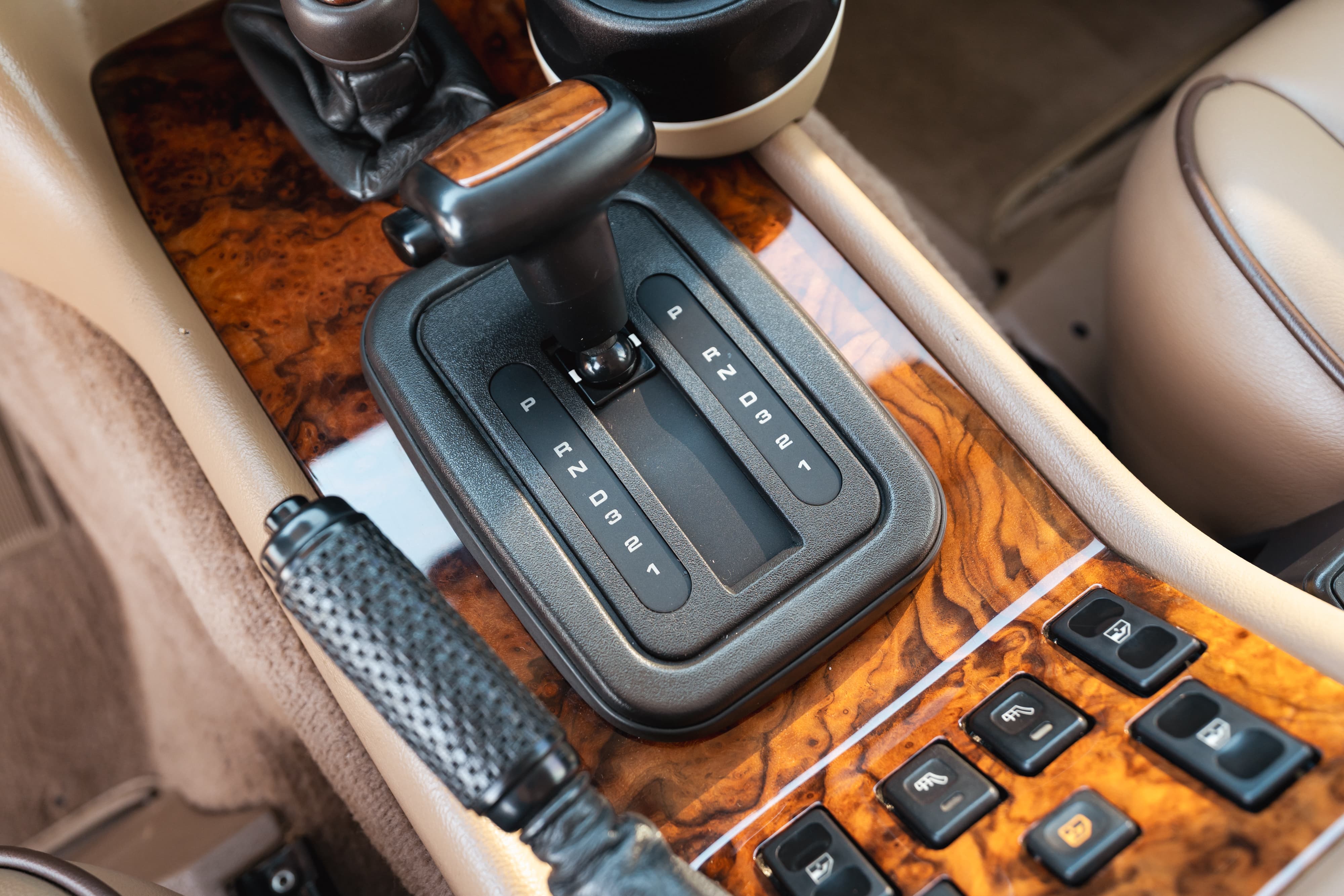 1995 Range Rover County interior: Automatic shifter, wood trim, and power window controls on the center console.