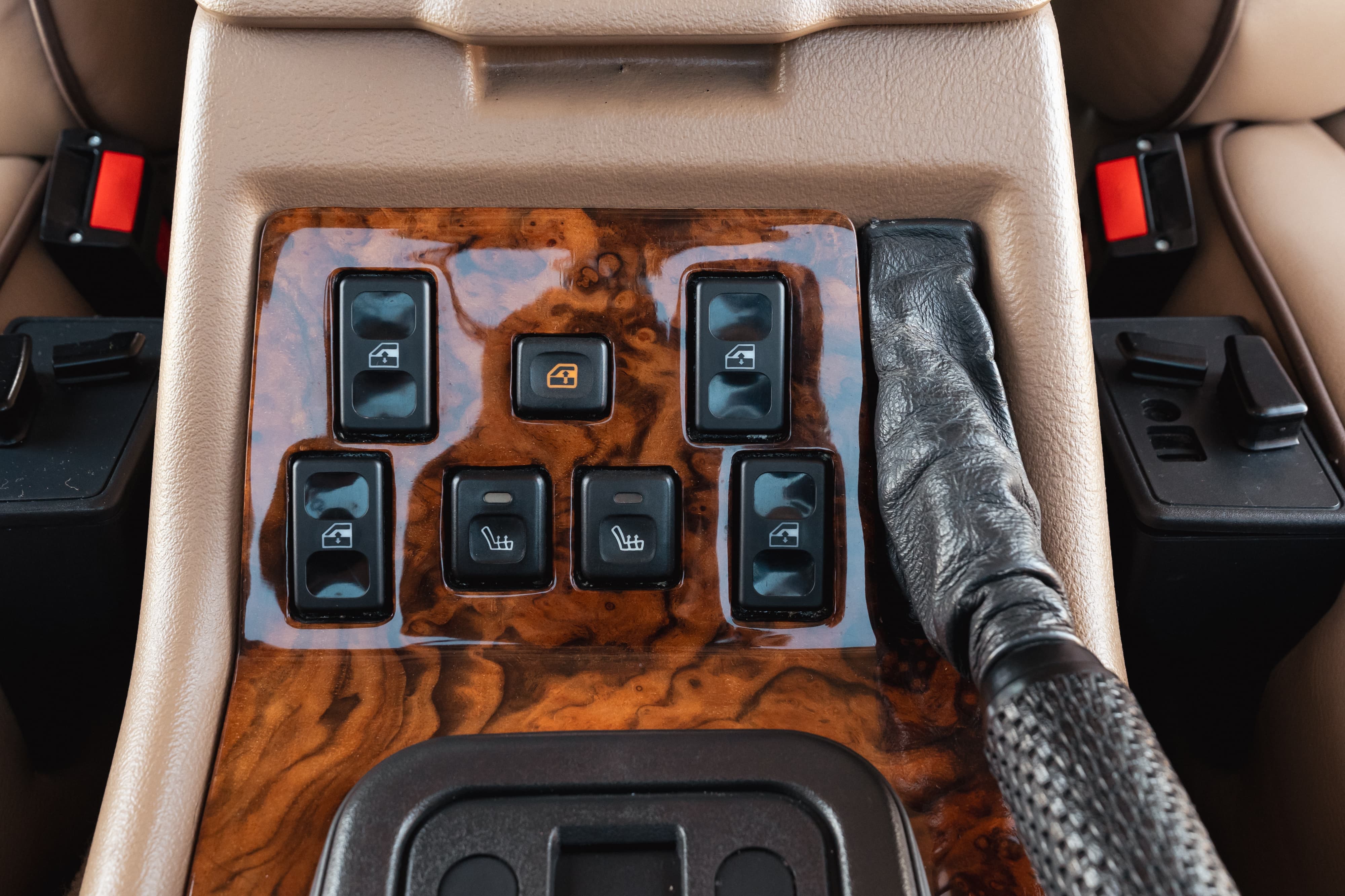 1995 Land Rover Range Rover County interior: wood trim, window and heated seat controls, leather gear shifter.