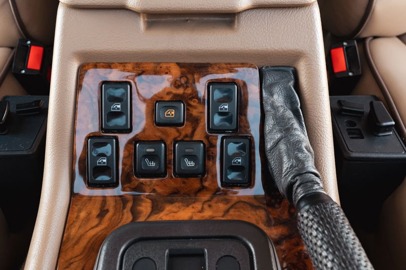 1995 Land Rover Range Rover County interior: wood trim, window and heated seat controls, leather gear shifter.