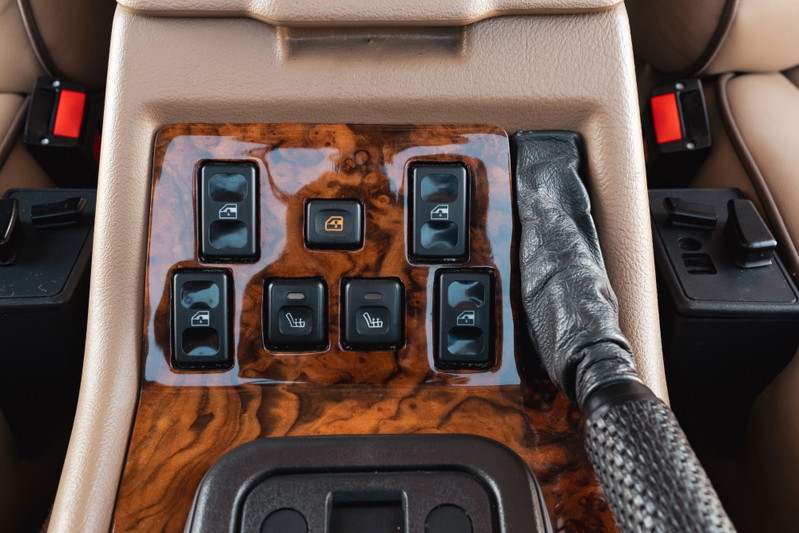 1995 Land Rover Range Rover County interior: wood trim, window and heated seat controls, leather gear shifter.