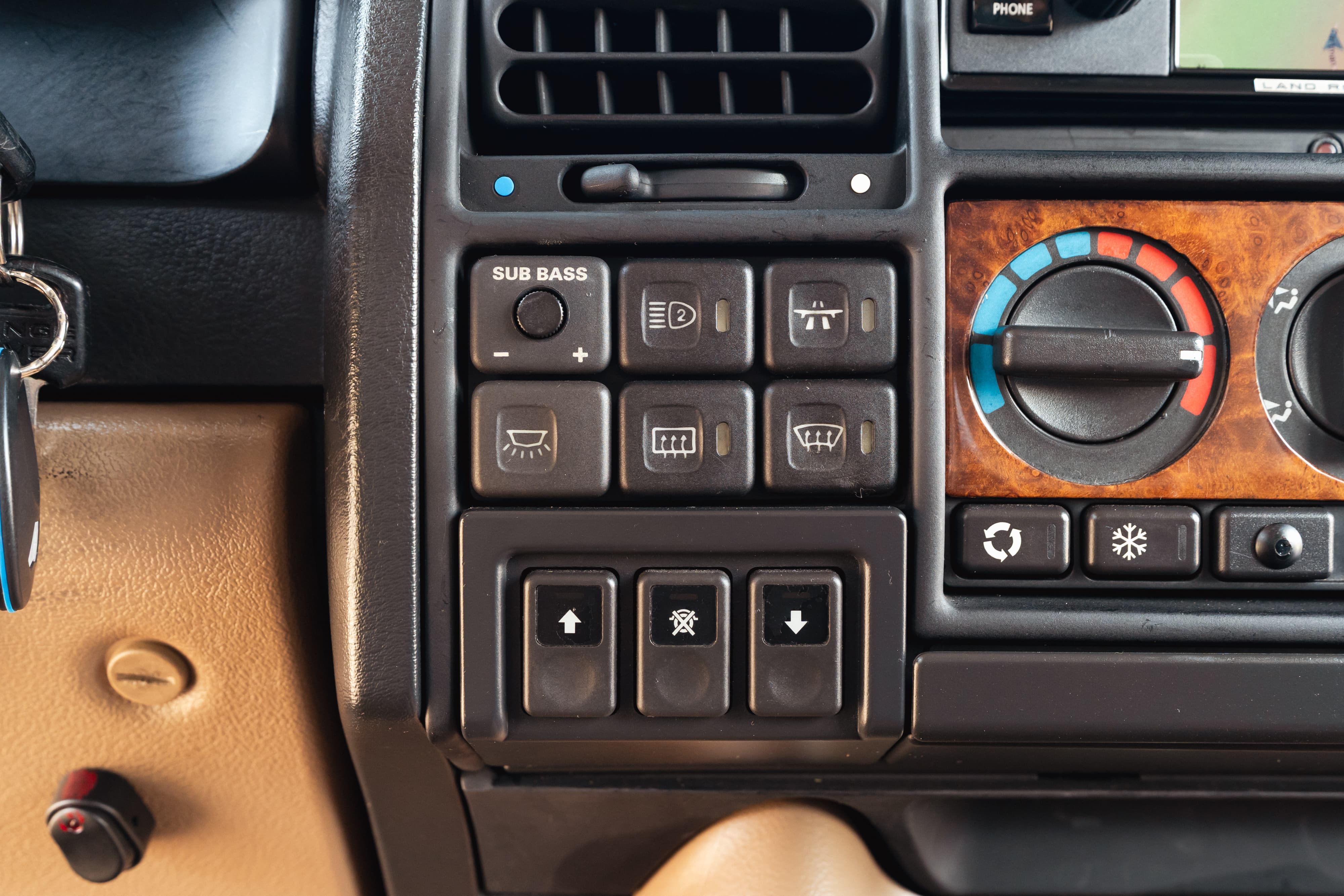 1995 Range Rover County interior detail. Buttons, vents, and faux wood trim visible.