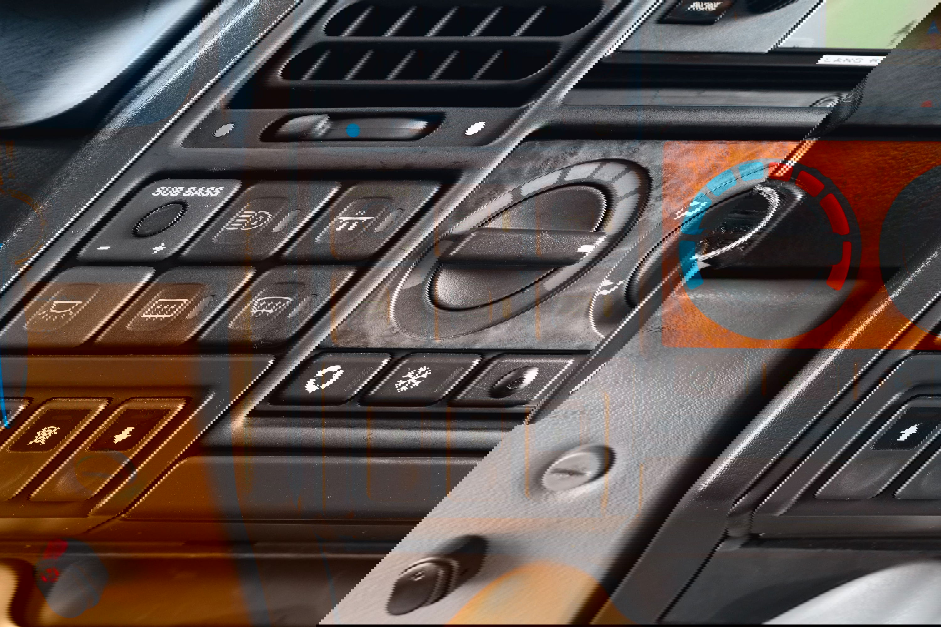 1995 Range Rover County interior detail. Buttons, vents, and faux wood trim visible.