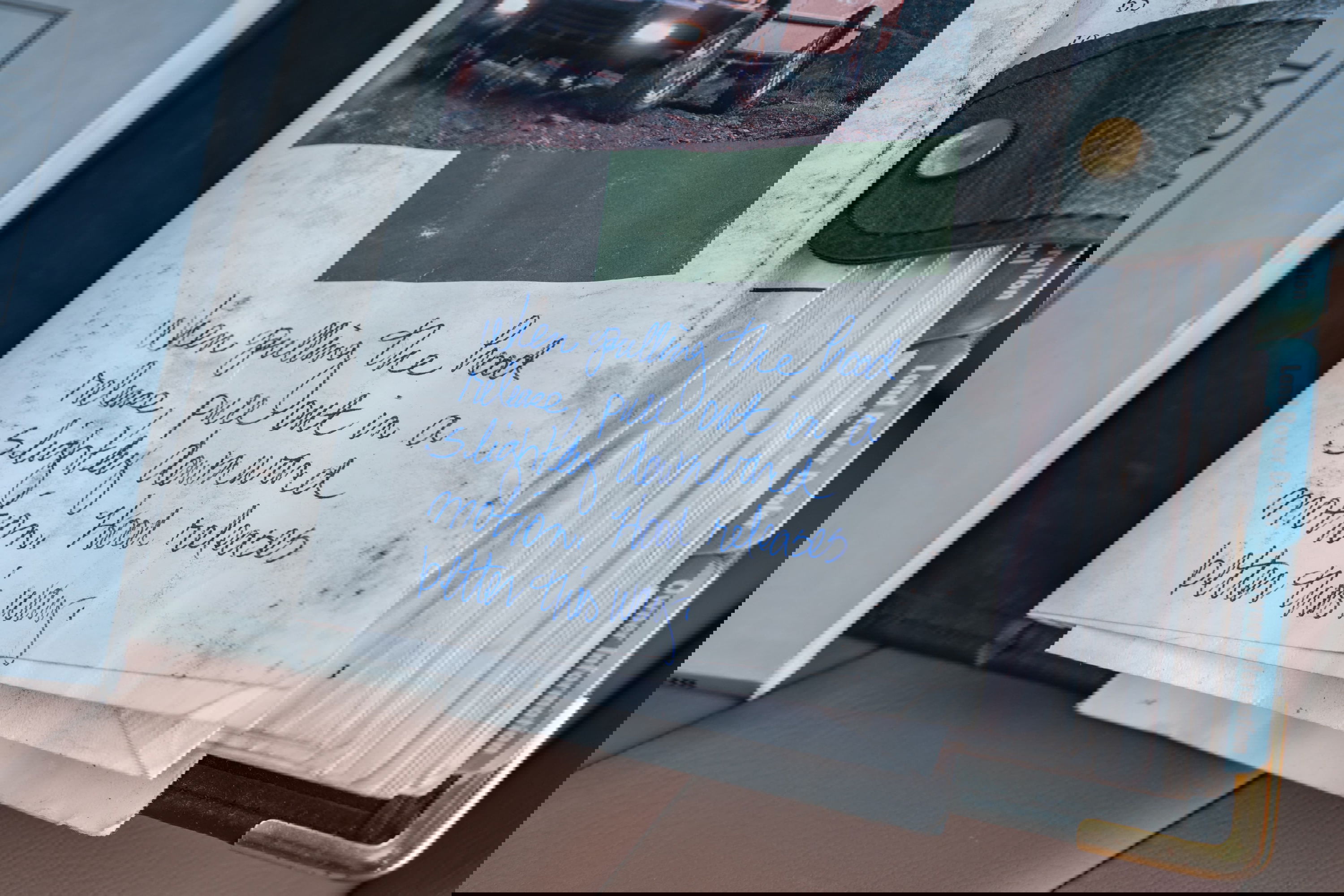 White 1995 Land Rover Range Rover County owner's manual with handwritten hood release instructions.