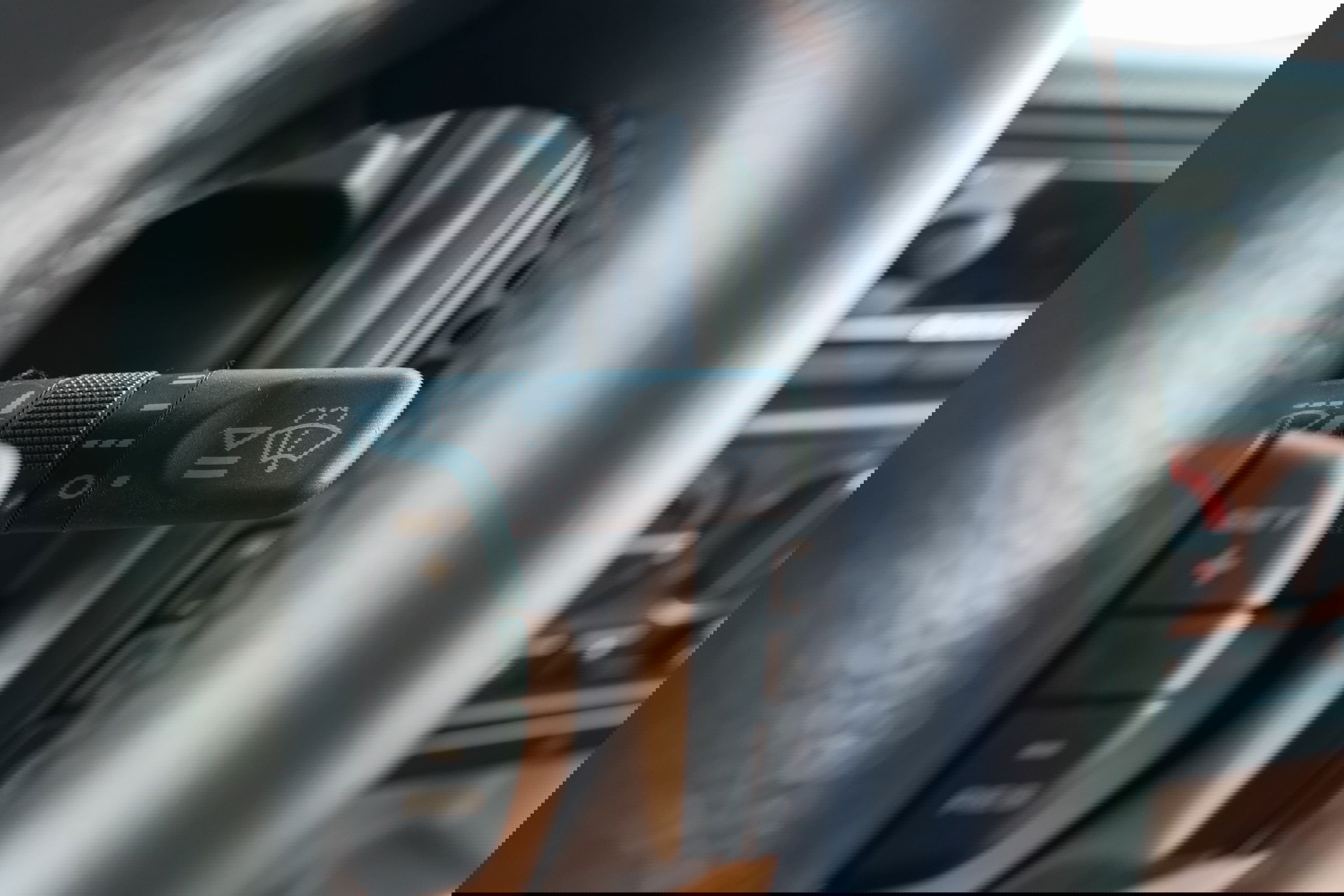 1995 white Land Rover Range Rover County steering wheel with wiper controls and cruise control buttons.