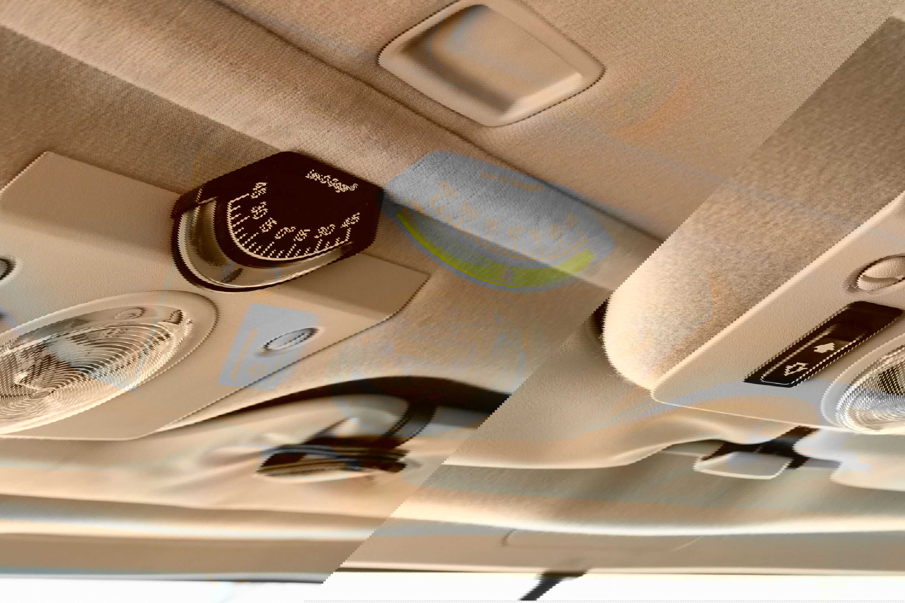 1995 white Land Rover Range Rover County dashboard inclinometer and dome light.