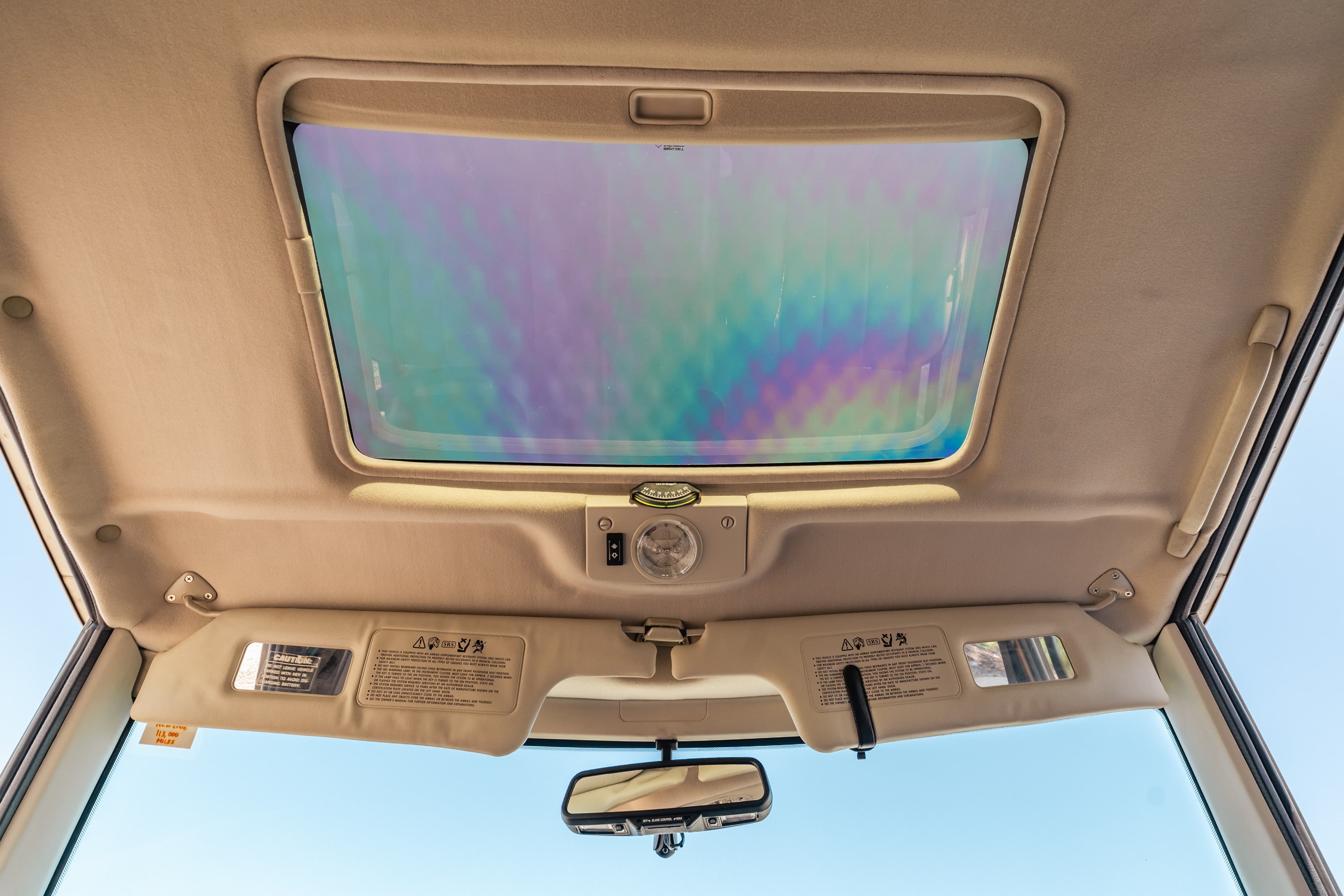 1995 white Range Rover County interior with sunroof and beige headliner.