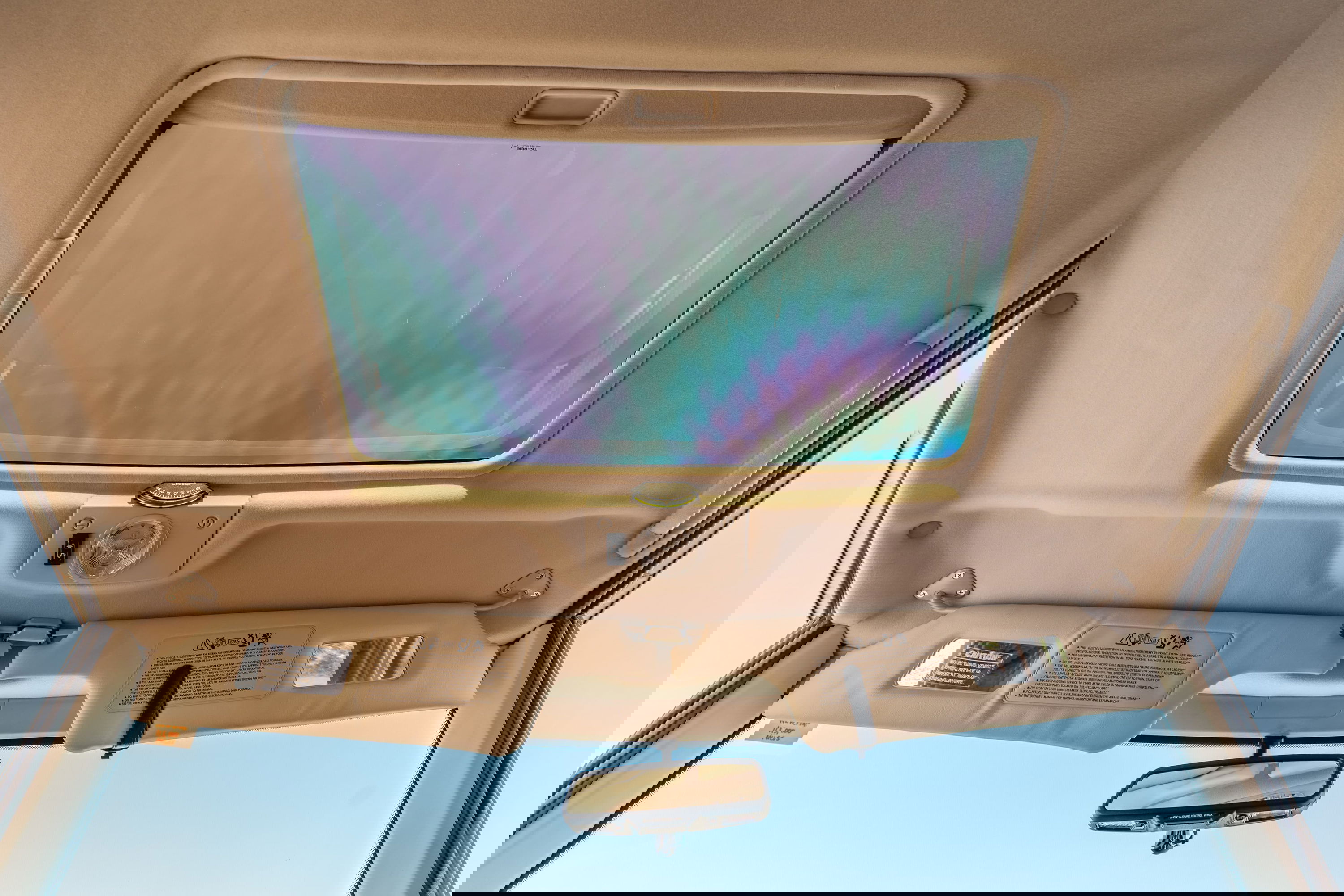 1995 white Range Rover County interior with sunroof and beige headliner.