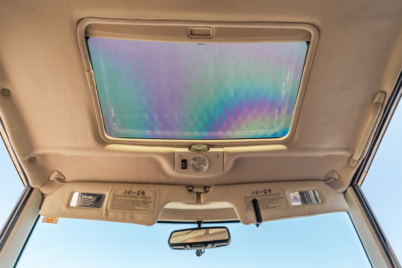 1995 white Range Rover County interior with sunroof and beige headliner.