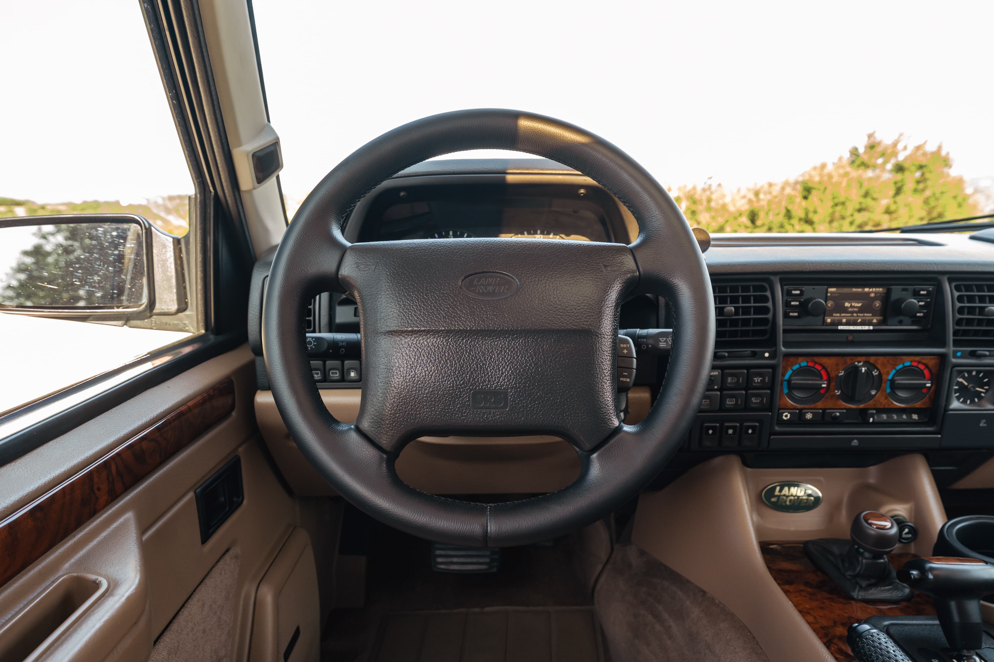 1995 Range Rover County interior: leather steering wheel, wood trim, central console.