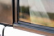 Close-up of a 1995 Range Rover County's bronze metallic body trim and tinted window with manufacturer markings.