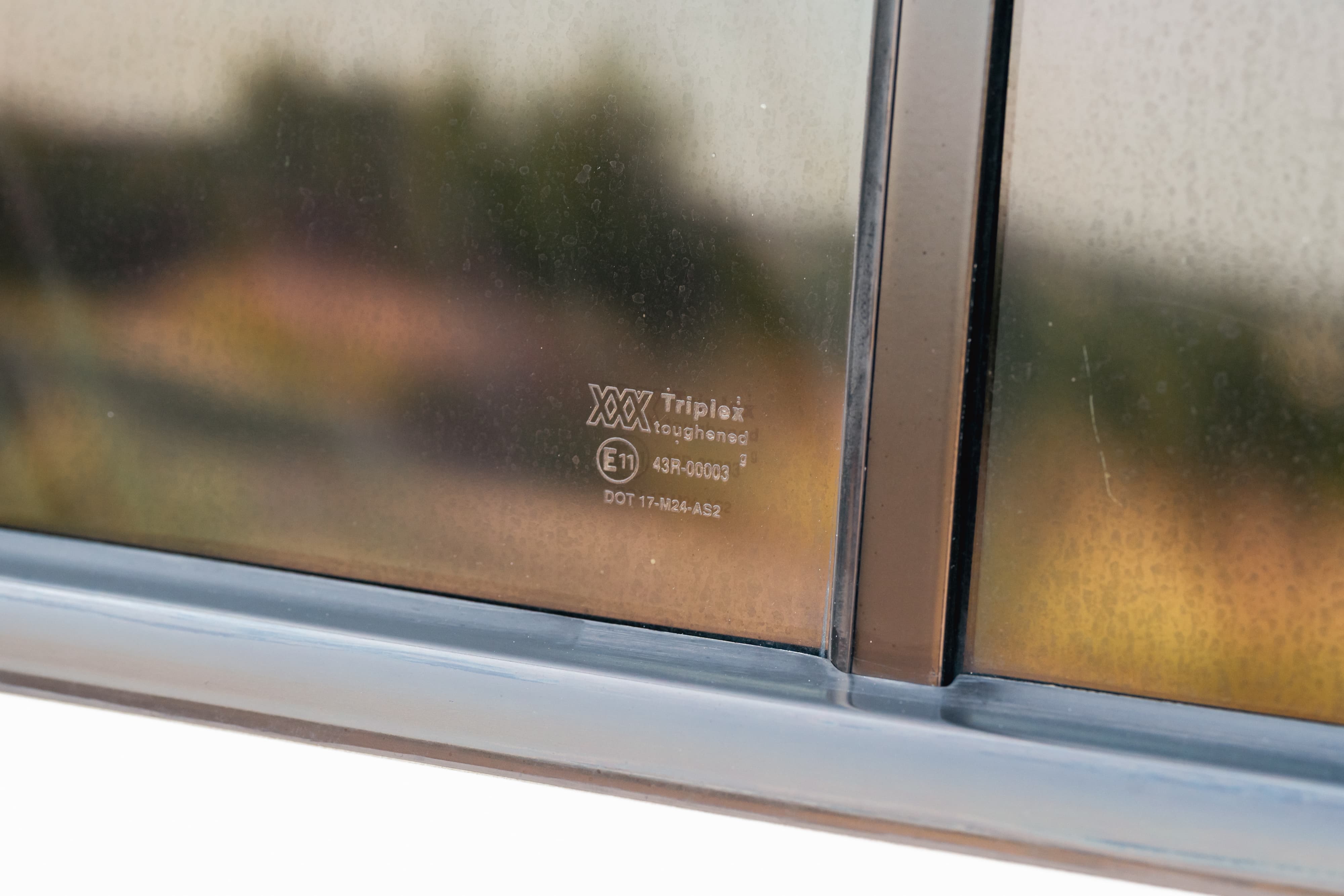 1995 white Range Rover County side window with Triplex toughened glass marking.